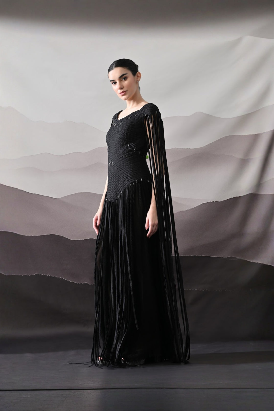 Black Gown With Silhouette Defined By Texture And Movement