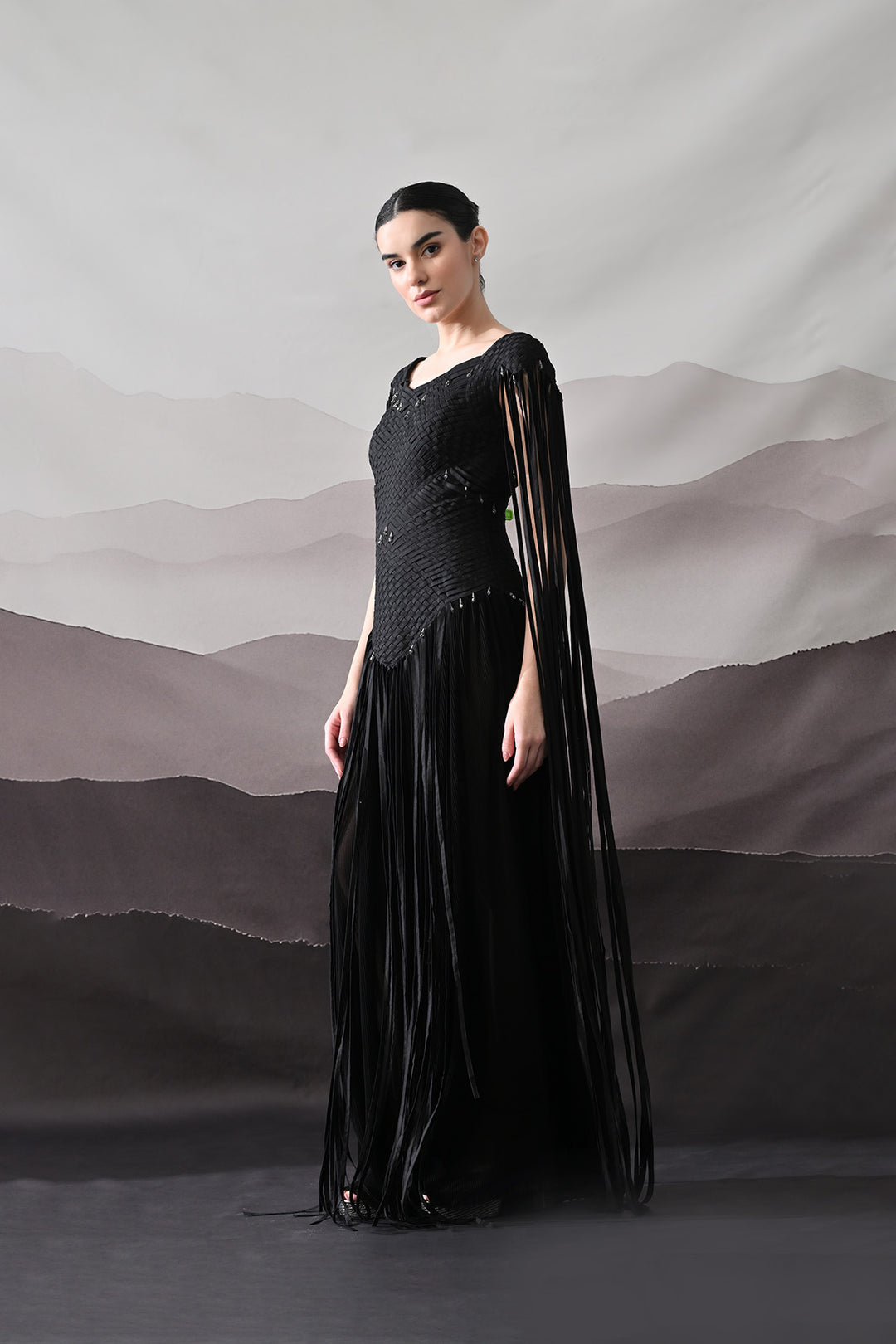 Black Gown With Silhouette Defined By Texture And Movement