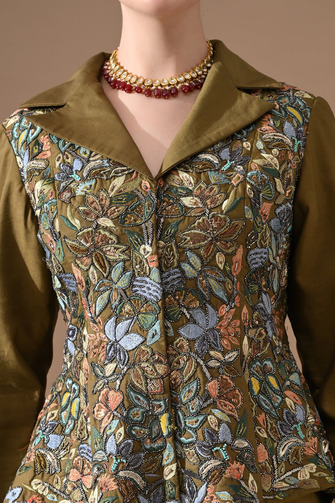 A Olive Green Jacket Features Intricate All-Over Embroidery With Skirt