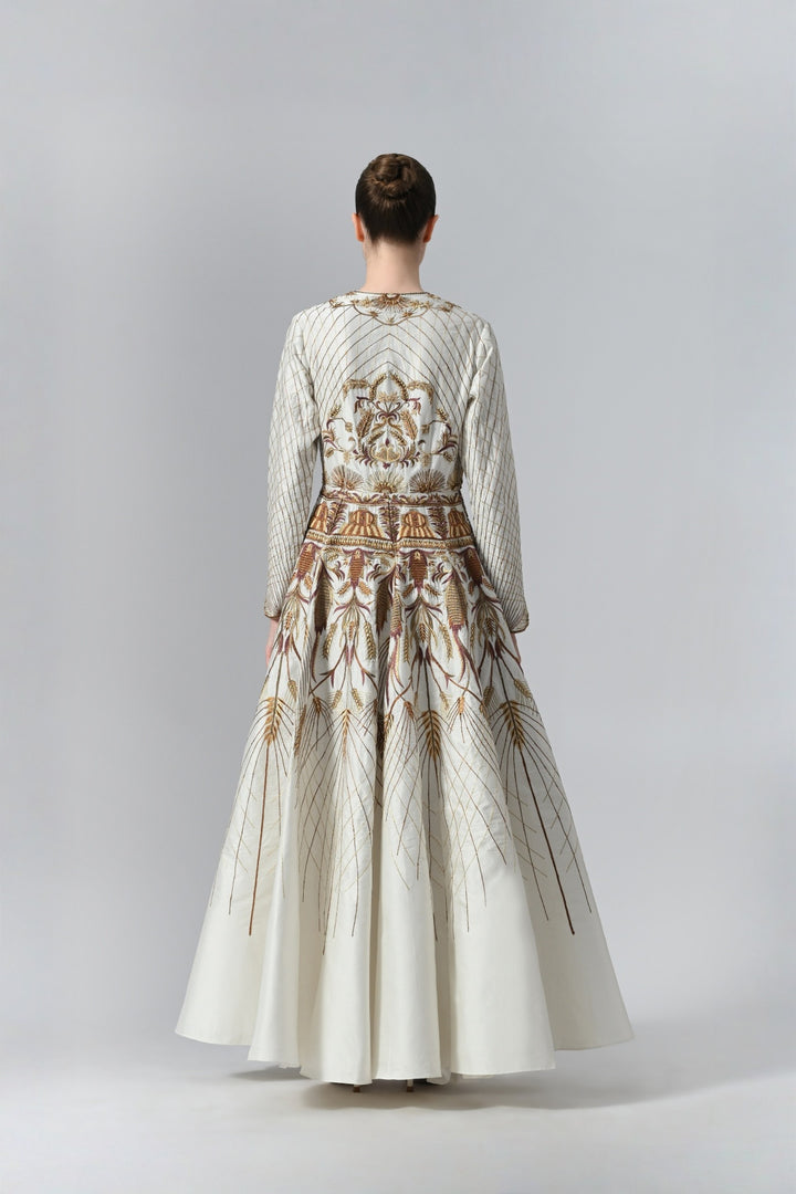 Ivory embroidered A-line gown featuring elegant round neckline, full-sleeves, structured bodice, and the gown is adorned with intricate botanical &amp; heritage-inspired motifs.