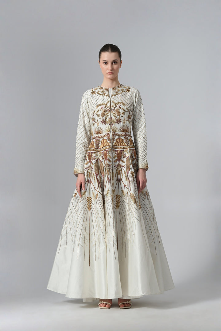 Ivory embroidered A-line gown featuring elegant round neckline, full-sleeves, structured bodice, and the gown is adorned with intricate botanical &amp; heritage-inspired motifs.