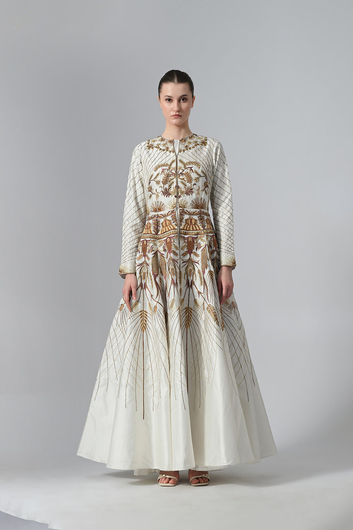 Ivory embroidered A-line gown featuring elegant round neckline, full-sleeves, structured bodice, and the gown is adorned with intricate botanical &amp; heritage-inspired motifs.