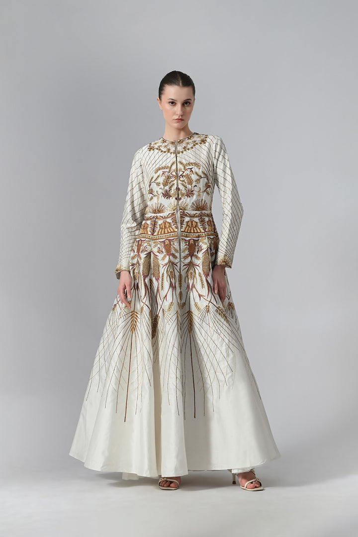 Ivory embroidered A-line gown featuring elegant round neckline, full-sleeves, structured bodice, and the gown is adorned with intricate botanical &amp; heritage-inspired motifs.