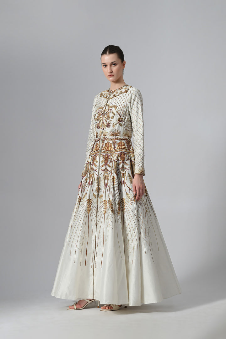 Ivory embroidered A-line gown featuring elegant round neckline, full-sleeves, structured bodice, and the gown is adorned with intricate botanical &amp; heritage-inspired motifs.