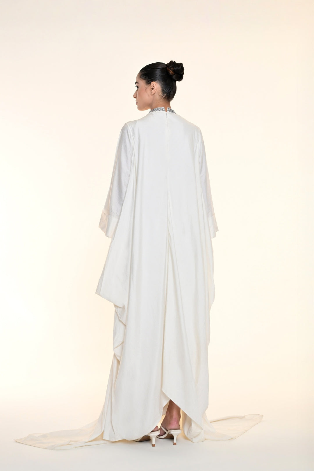 Ivory draped overlay dress with tonal floral embroidery, cascading panels, and relaxed statement sleeves.