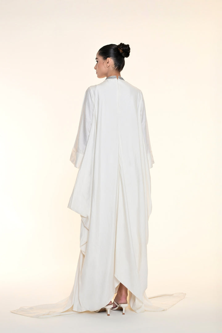 Ivory draped overlay dress with tonal floral embroidery, cascading panels, and relaxed statement sleeves.