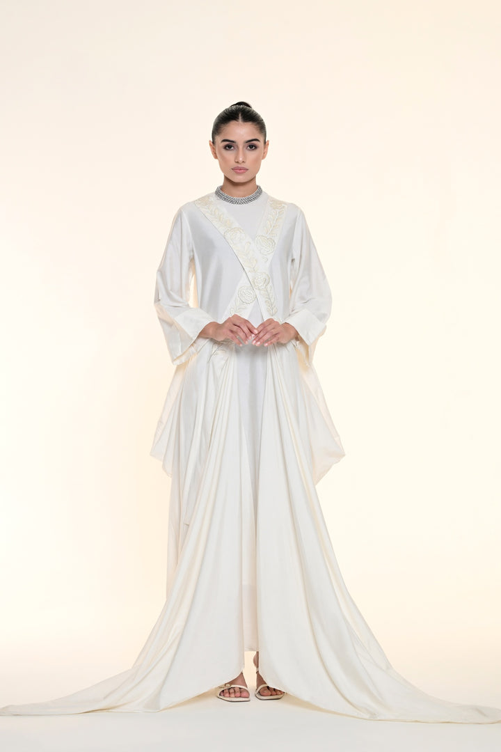 Ivory draped overlay dress with tonal floral embroidery, cascading panels, and relaxed statement sleeves.