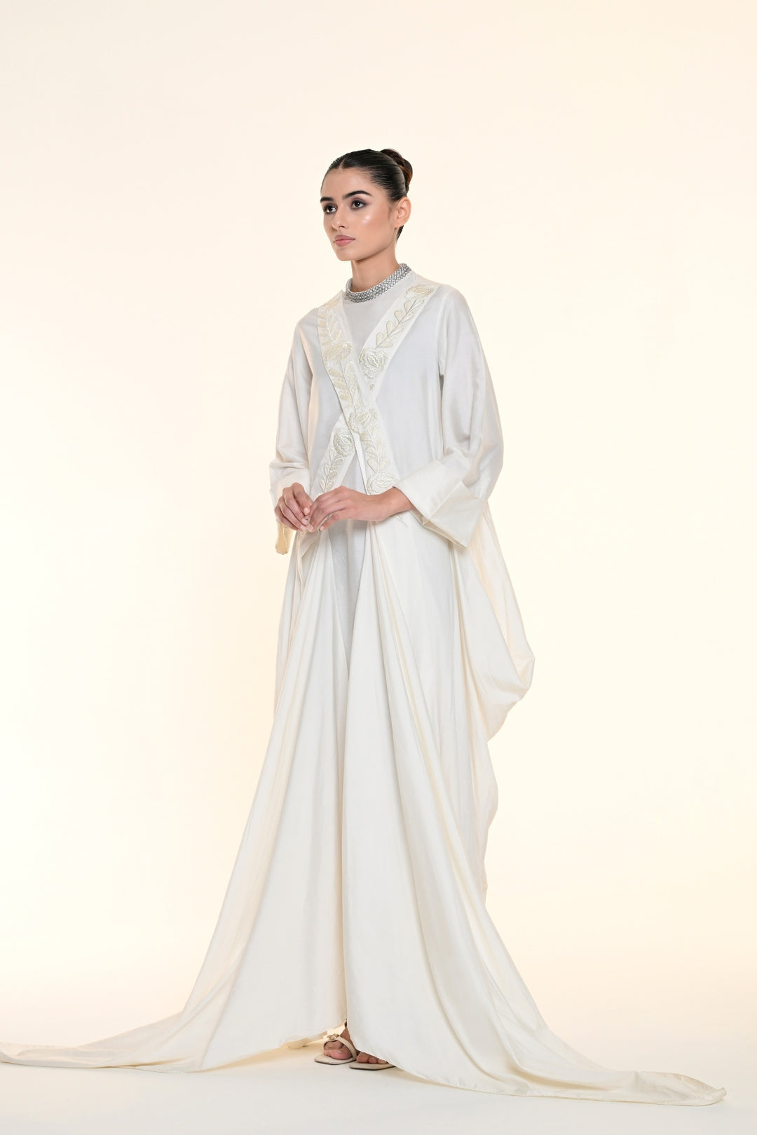 Ivory draped overlay dress with tonal floral embroidery, cascading panels, and relaxed statement sleeves.