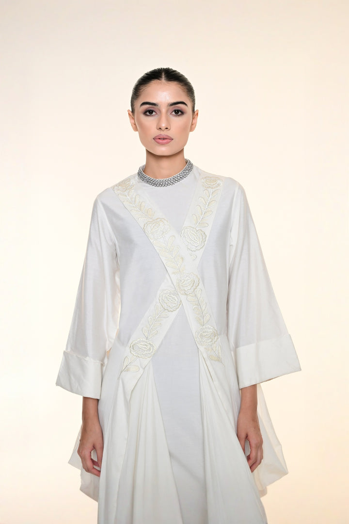 Ivory draped overlay dress with tonal floral embroidery, cascading panels, and relaxed statement sleeves.
