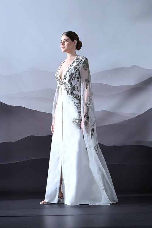 Ivory Gown With Hand-Embroidered Motifs And Sheer Cape Sleeves