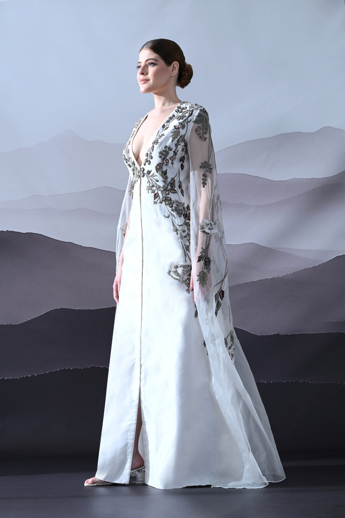 Ivory Gown with Hand-Embroidered Motifs and Sheer Cape Sleeves