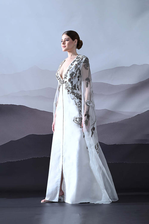 Ivory Gown With Hand-Embroidered Motifs And Sheer Cape Sleeves