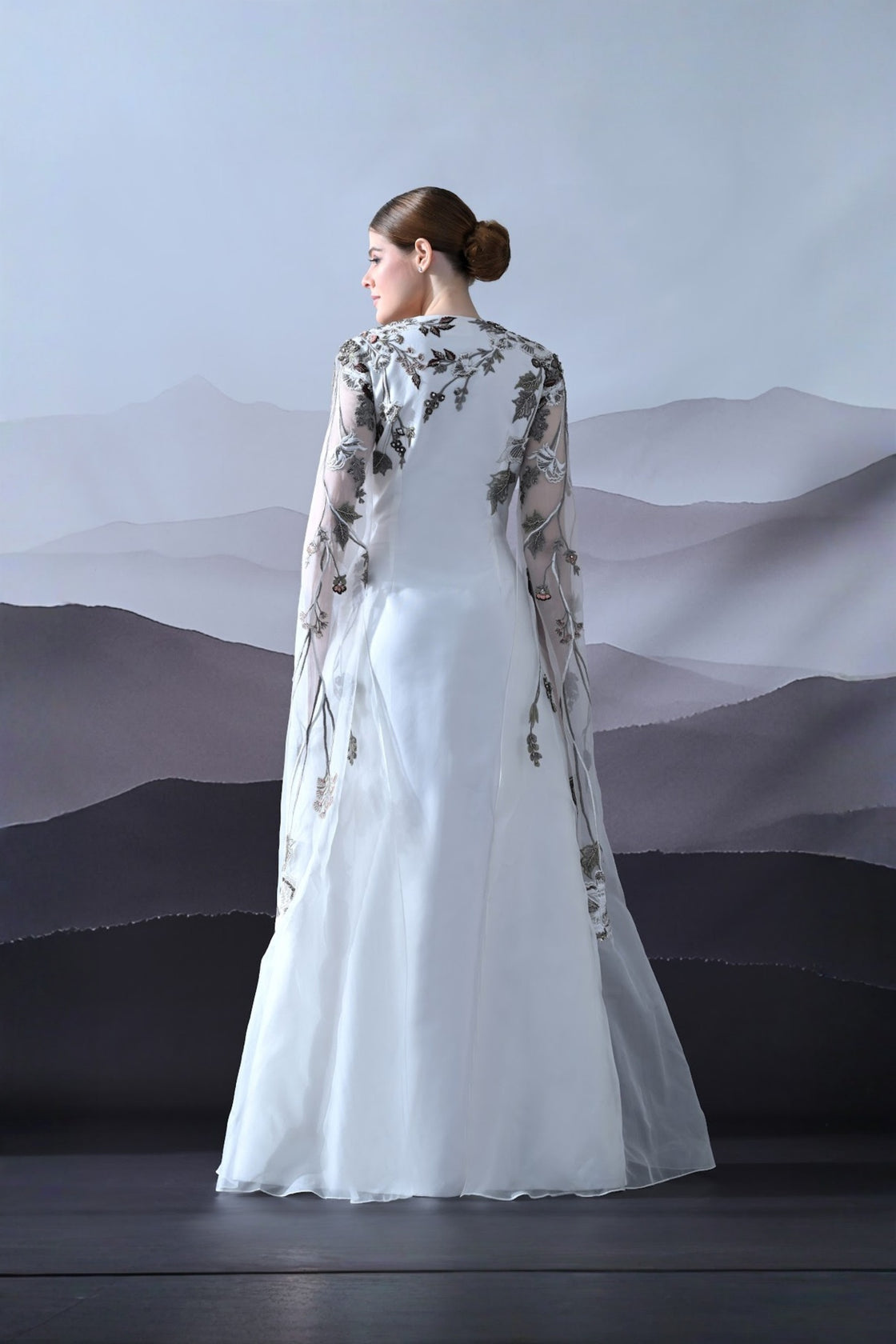 Ivory Gown With Hand-Embroidered Motifs And Sheer Cape Sleeves