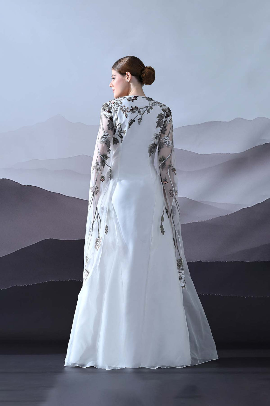 Ivory Gown With Hand-Embroidered Motifs And Sheer Cape Sleeves