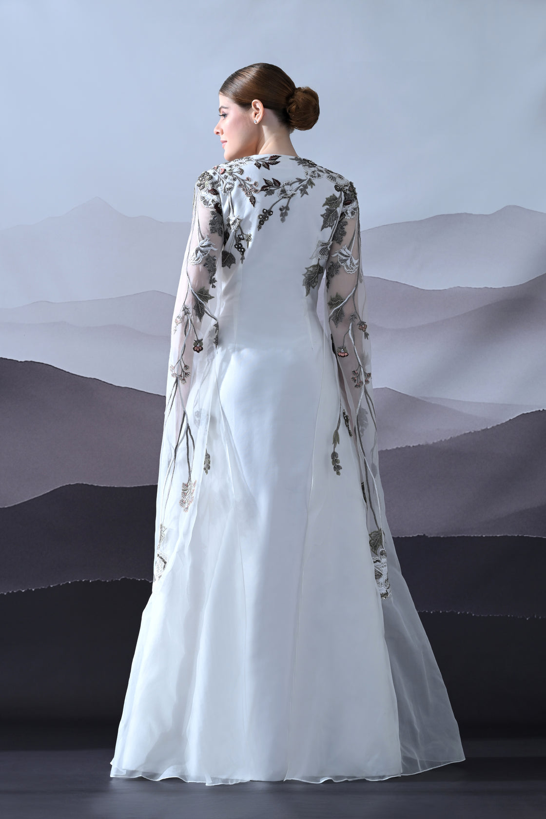 Ivory Gown with Hand-Embroidered Motifs and Sheer Cape Sleeves