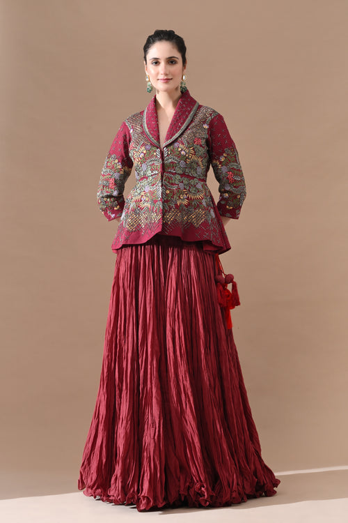 A maroon jacket features intricate all-over embroidery with skirt