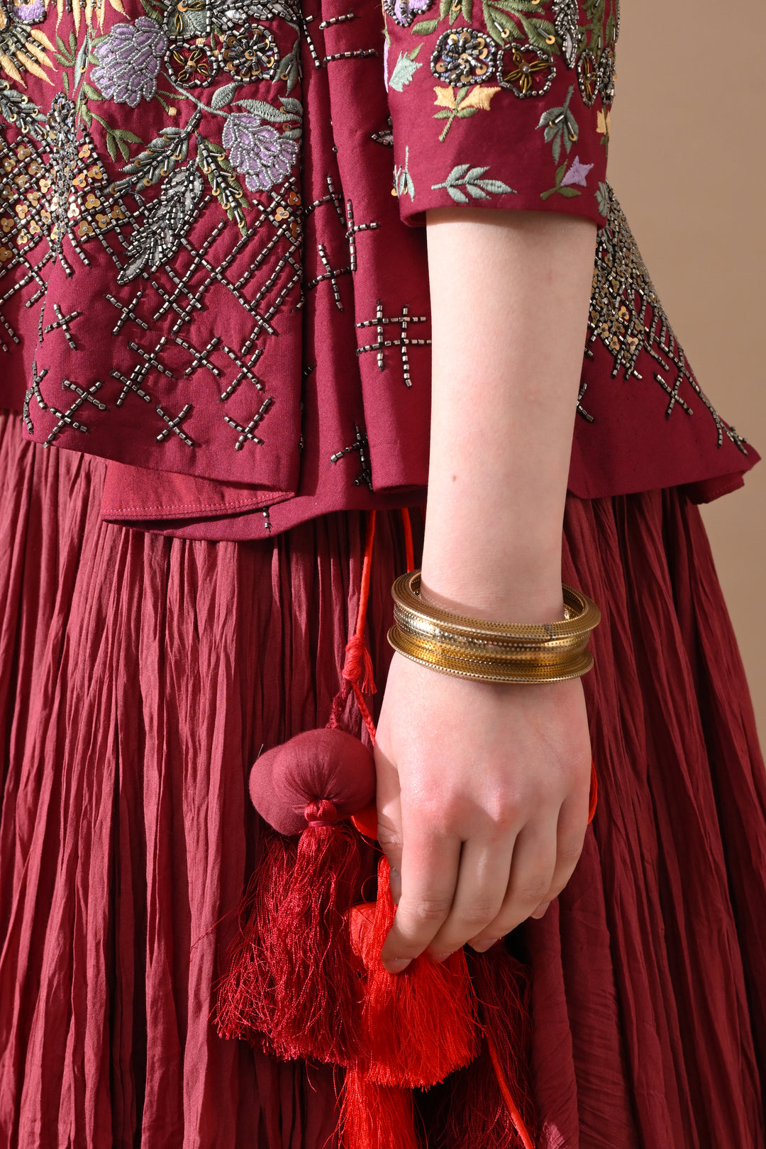 A Maroon Jacket Features Intricate All-Over Embroidery With Skirt
