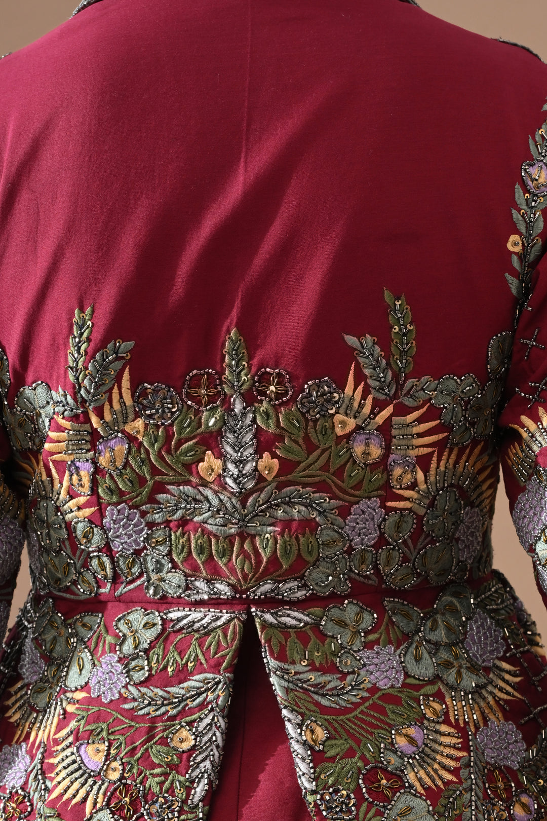 A Maroon Jacket Features Intricate All-Over Embroidery With Skirt