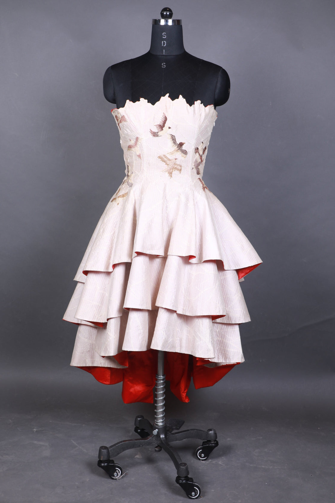 White dress on a mannequin against a gray background