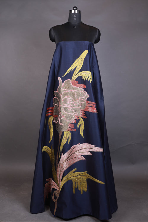 Navy blue umbrella with colorful floral embroidery on a gray background