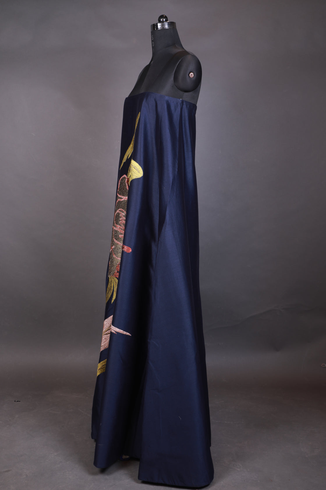 Folded umbrella with floral design on a gray background