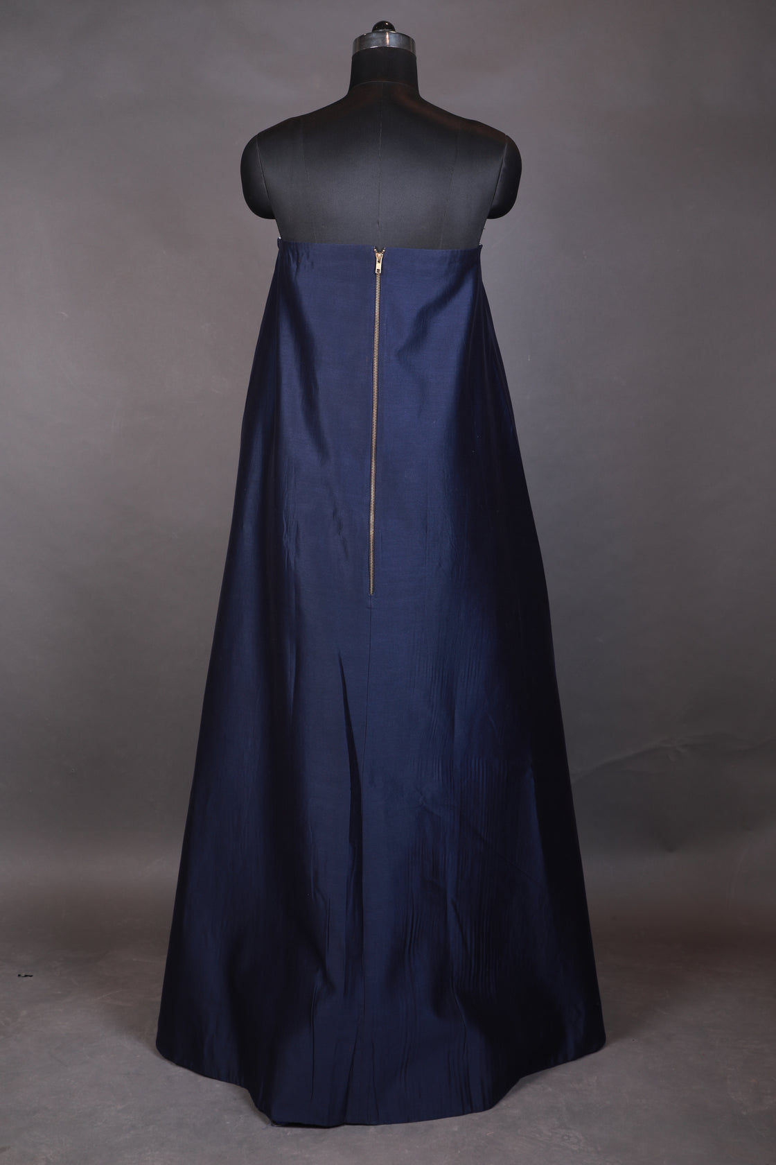 Navy blue dress on a mannequin against a plain background