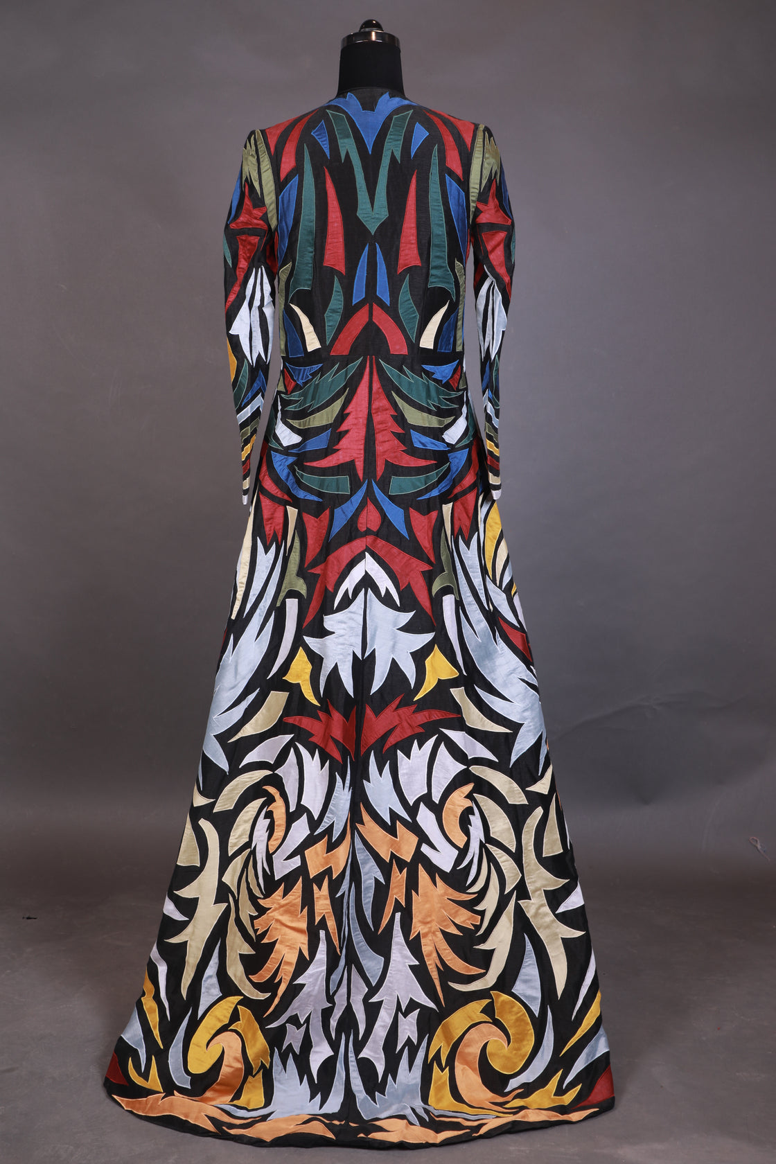 Hooded, floor length cotton silk gown, surfaced with colorful appliqué work all over.