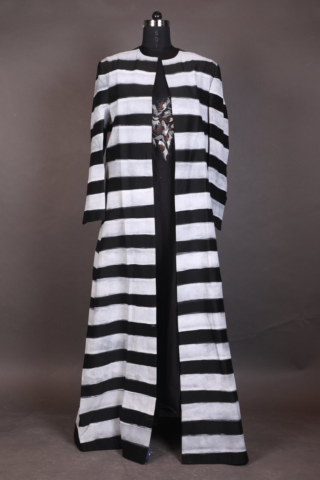 A black cotton silk floor-length jacket with block printed along with embraided neck inner