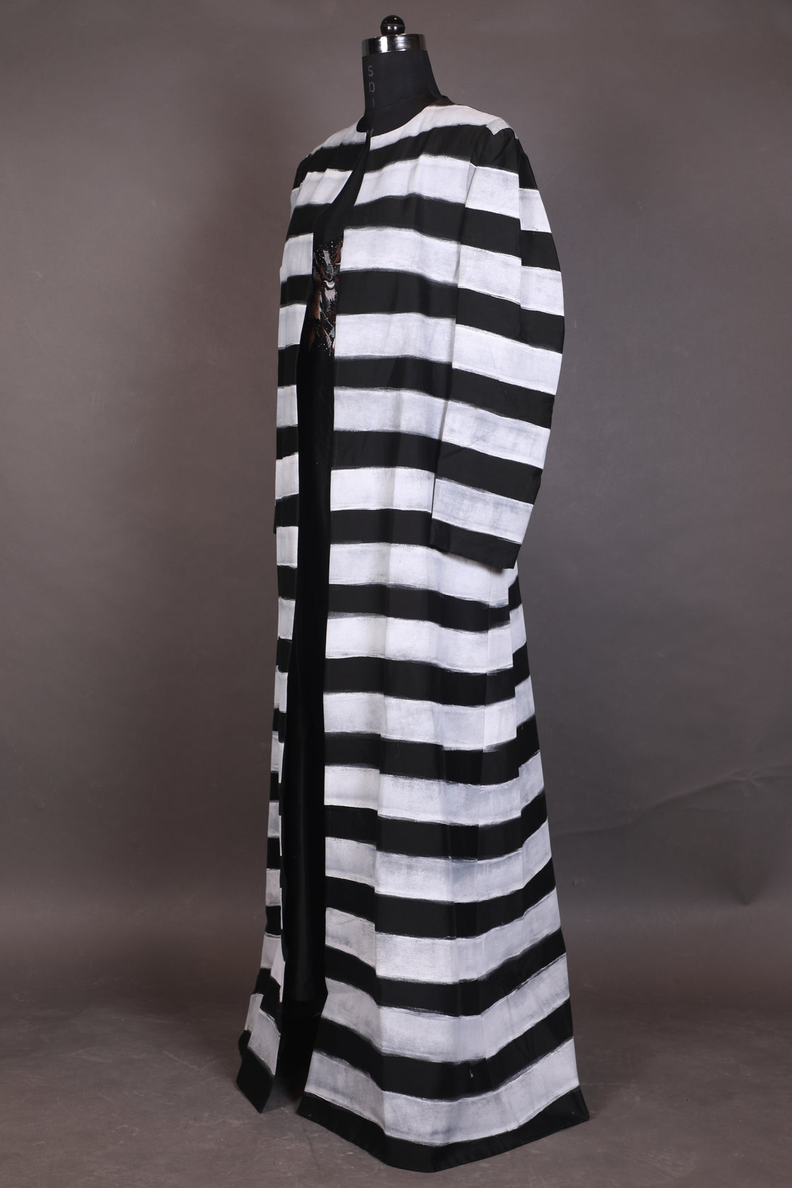 A black cotton silk floor-length jacket with block printed along with embraided neck inner