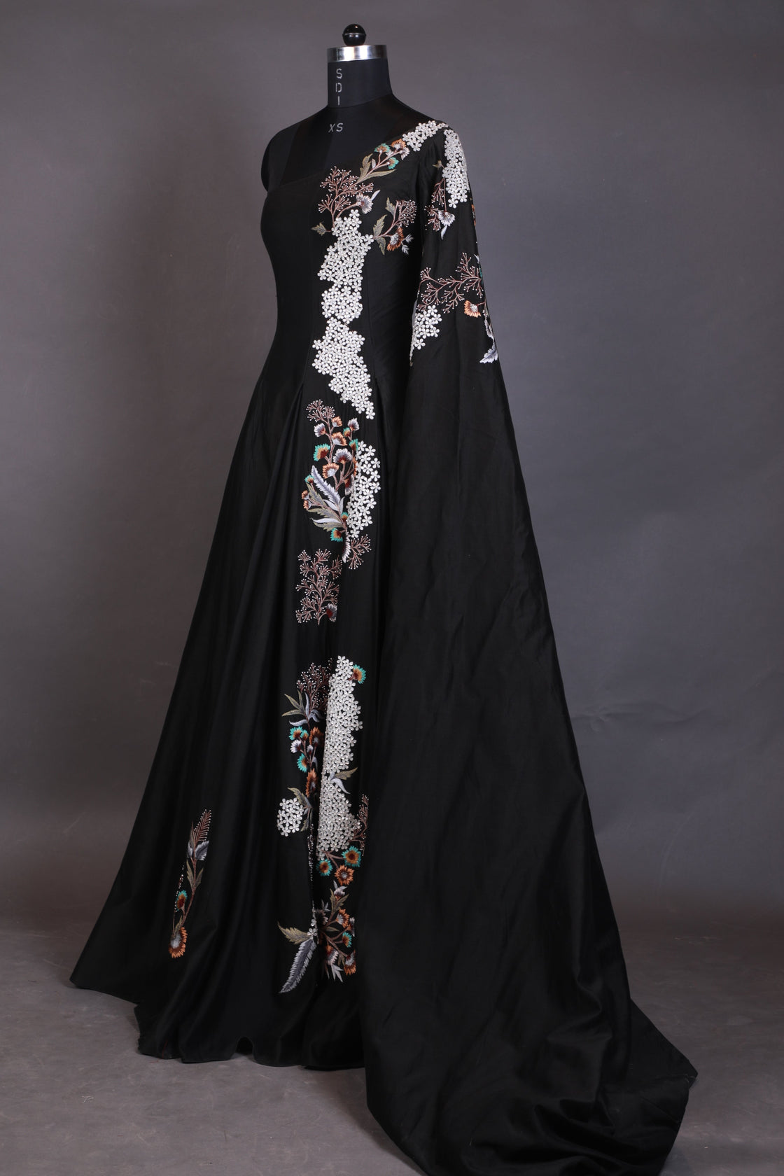 Black umbrella with floral embroidery on a gray background