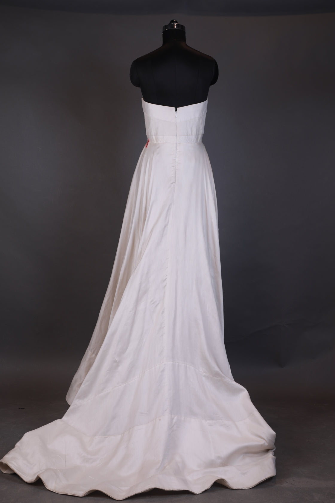 White dress on a mannequin against a dark background
