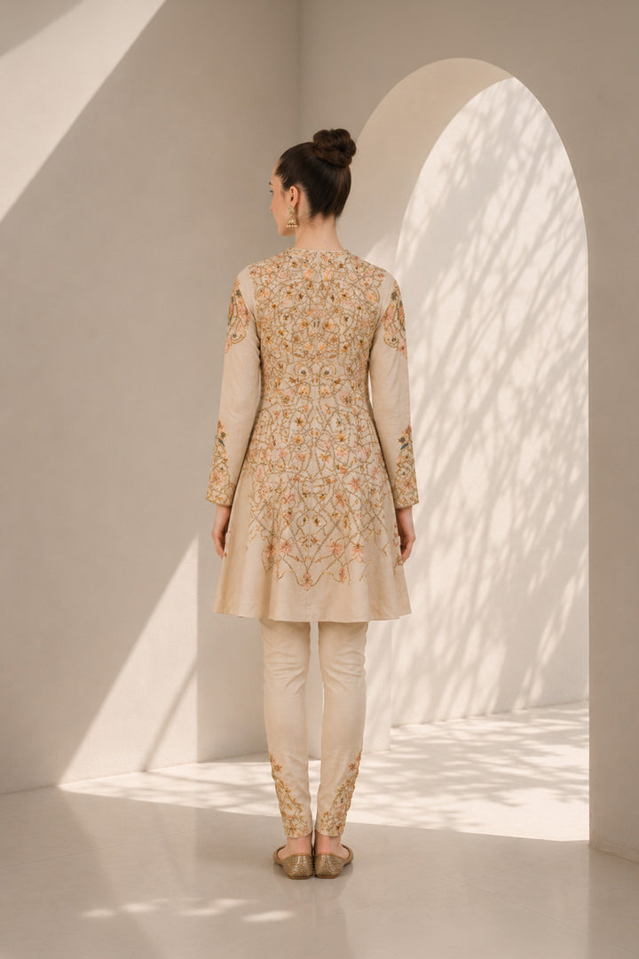 Ivory embroidered kurta set featuring a flattering fit-and-flare silhouette and refined artisanal detailing.