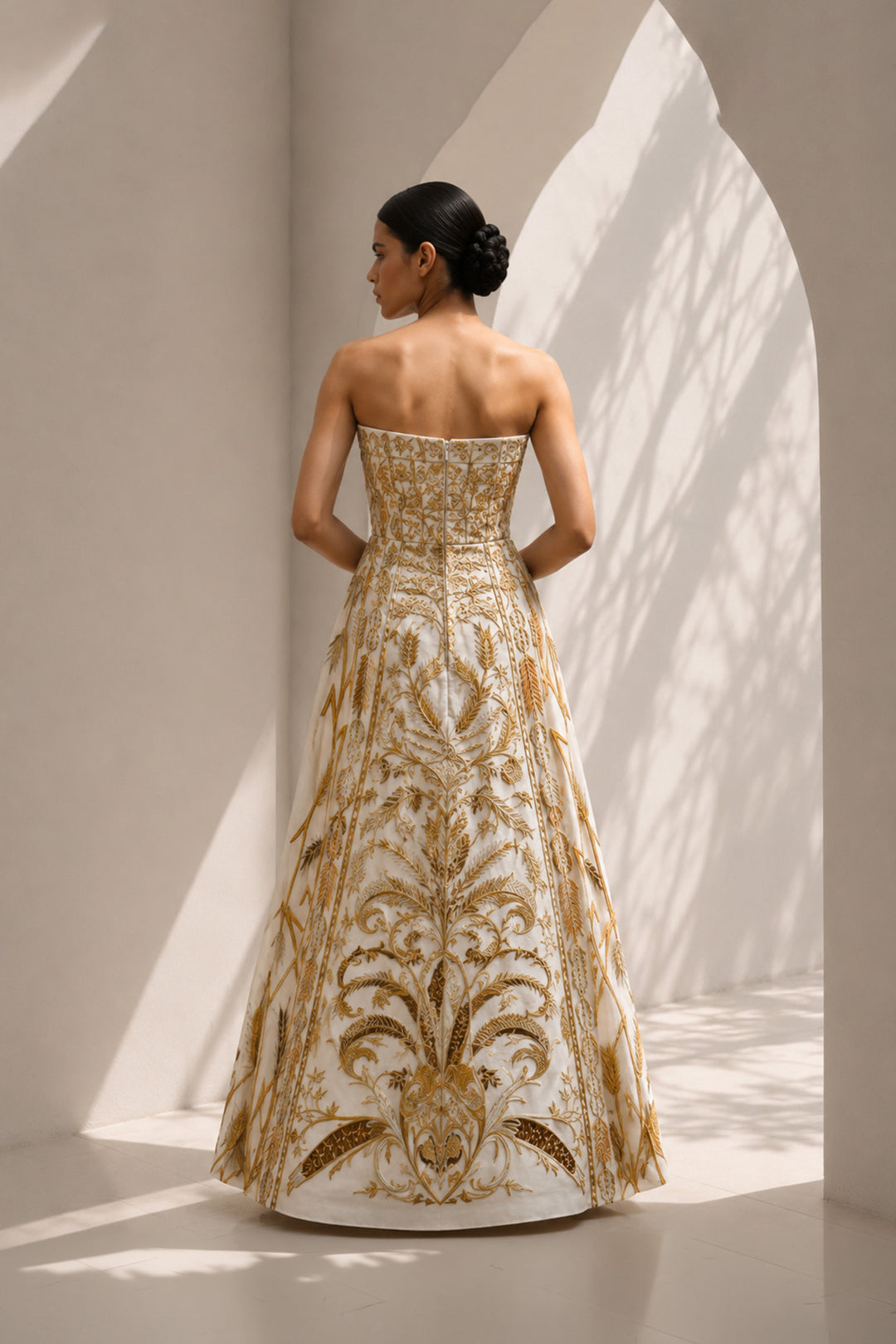 Ivory strapless sweetheart neckline statement gown enriched with gold embroidery.