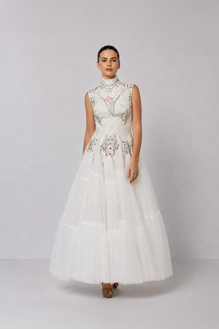 Ivory tiered tulle gown with embroidered bodice and high-neck detailing.