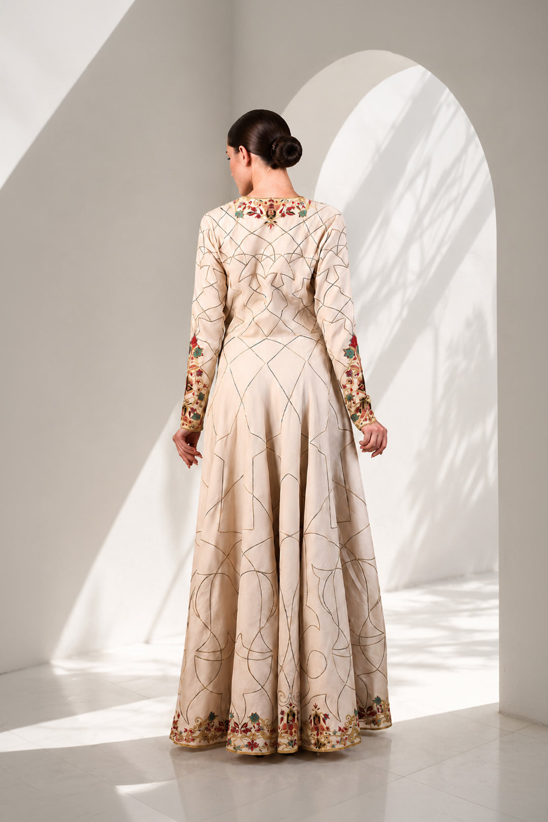 Ivory elegant overlap anarkali featuring flattering V-neckline with full sleeves, and adorned with delicate geometric linework &amp; multicolor floral embroidery.