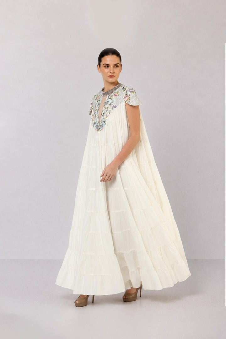 Ivory Tiered Gown With Embroidered Yoke And Cascading Ruffle Hem.
