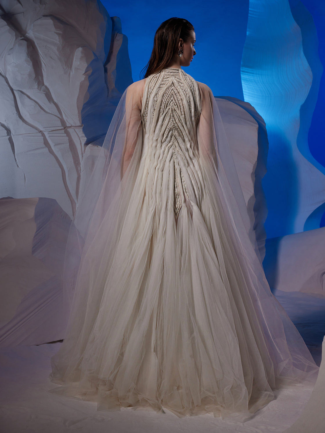 Ivory gown featuring pleating textured details.