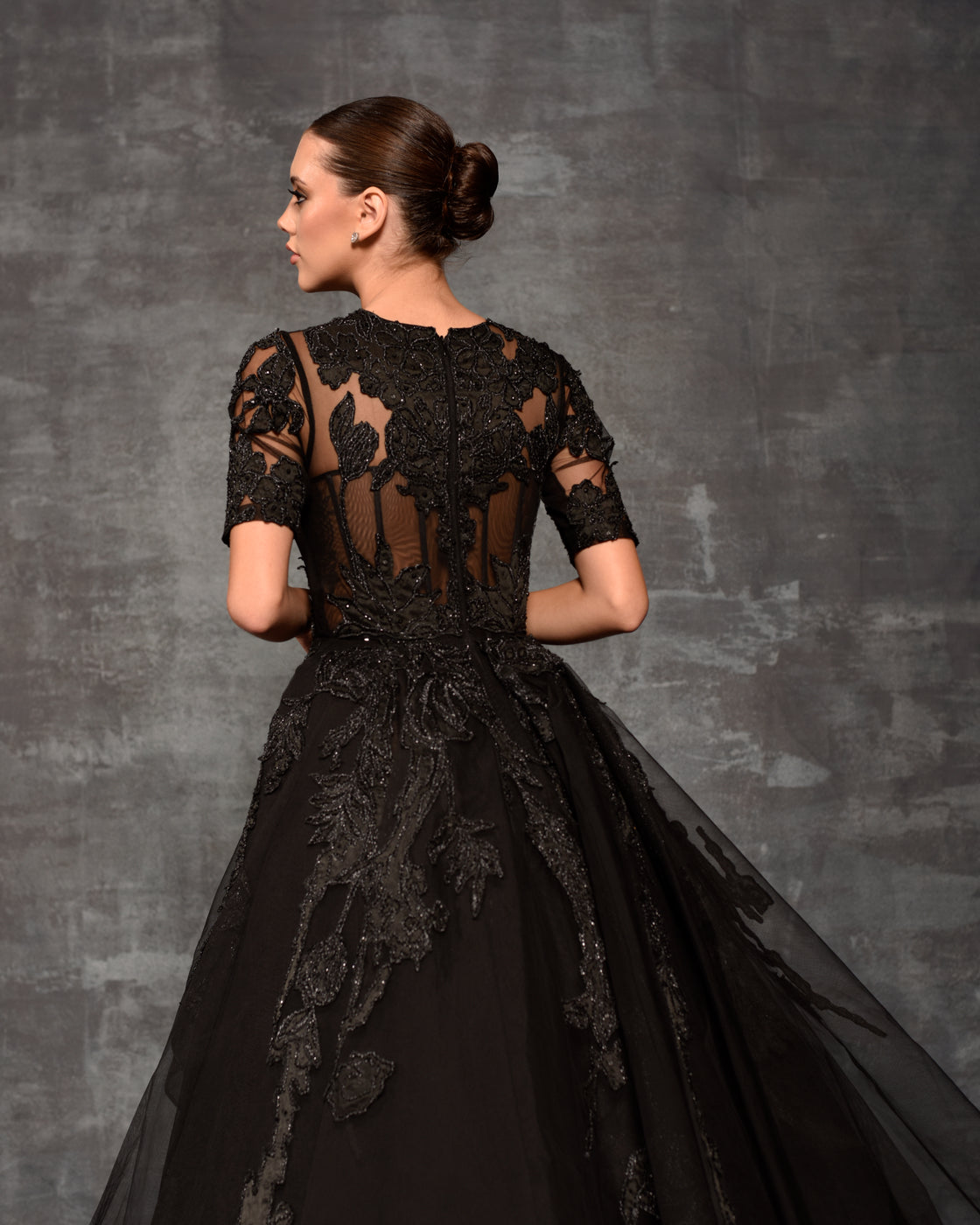 Black net fabric sheer ball gown enhanced with applique work
