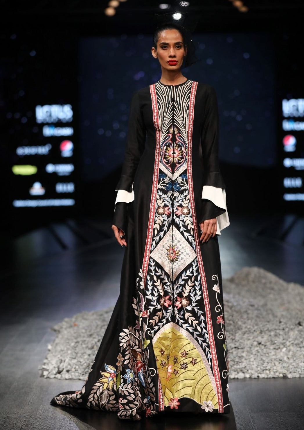 Floor-length embroidered gown with a mini trail and bell sleeves