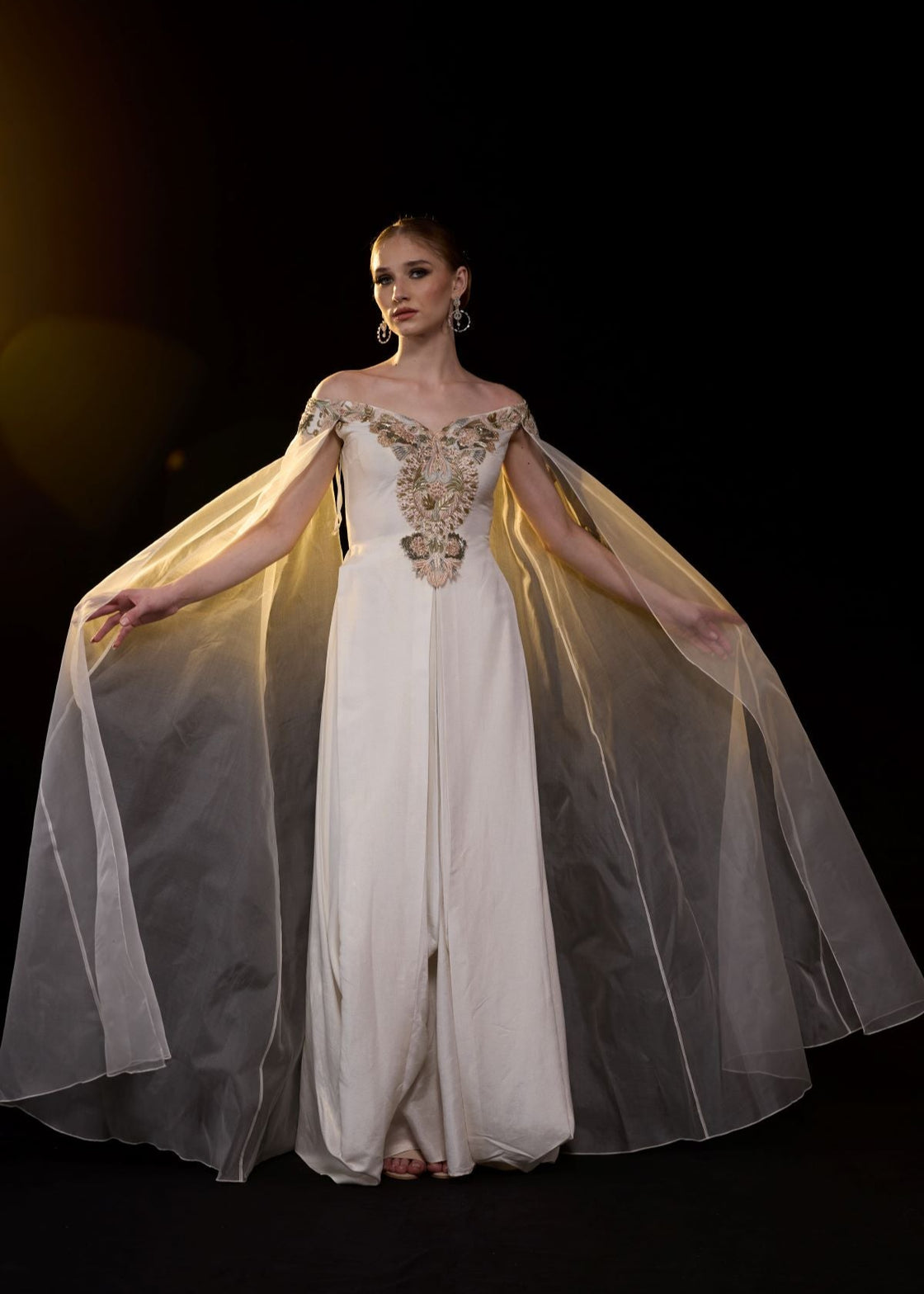 Off-shoulder gown features delicate floral embroidery