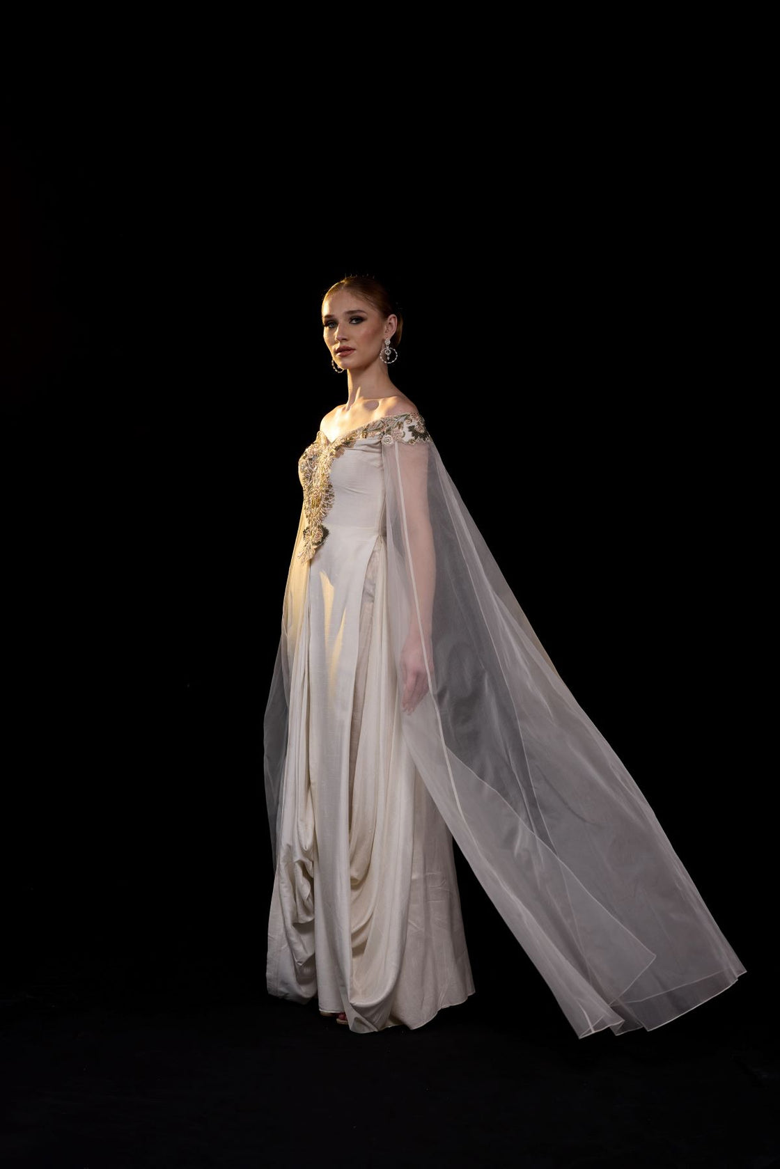 Off-shoulder gown features delicate floral embroidery