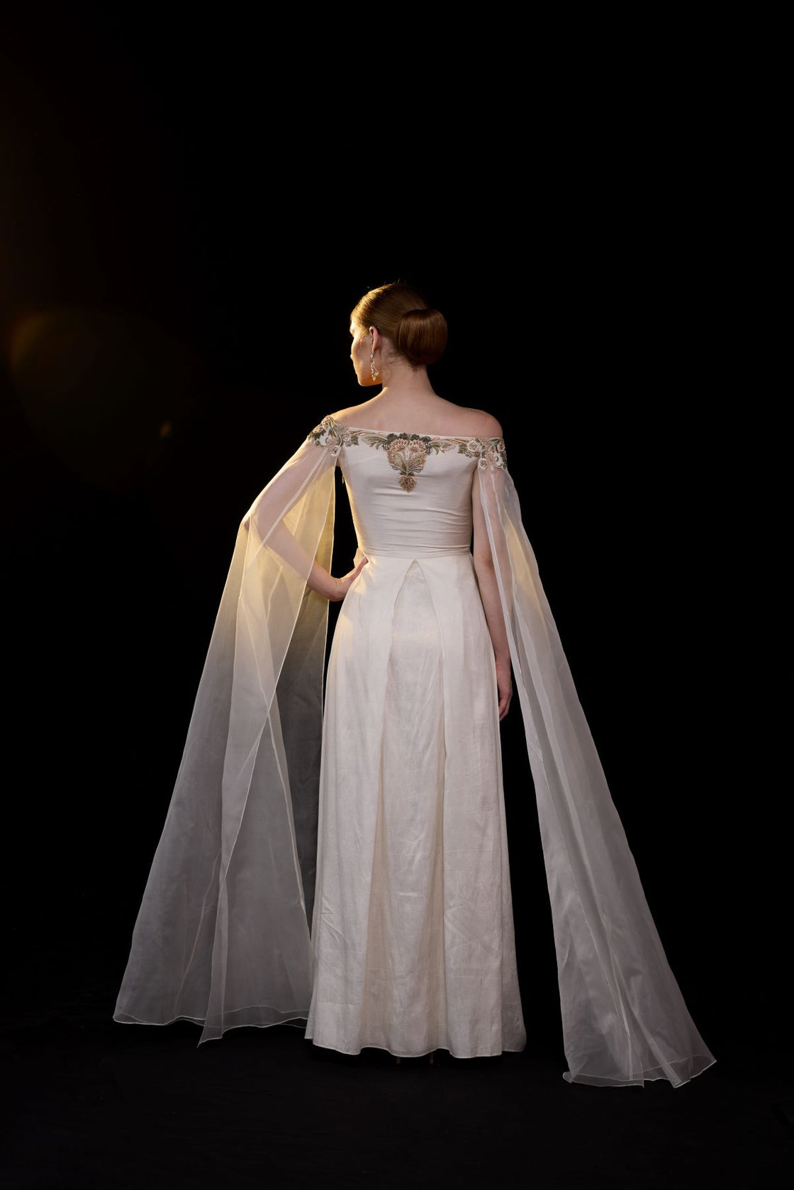 Off-shoulder gown features delicate floral embroidery