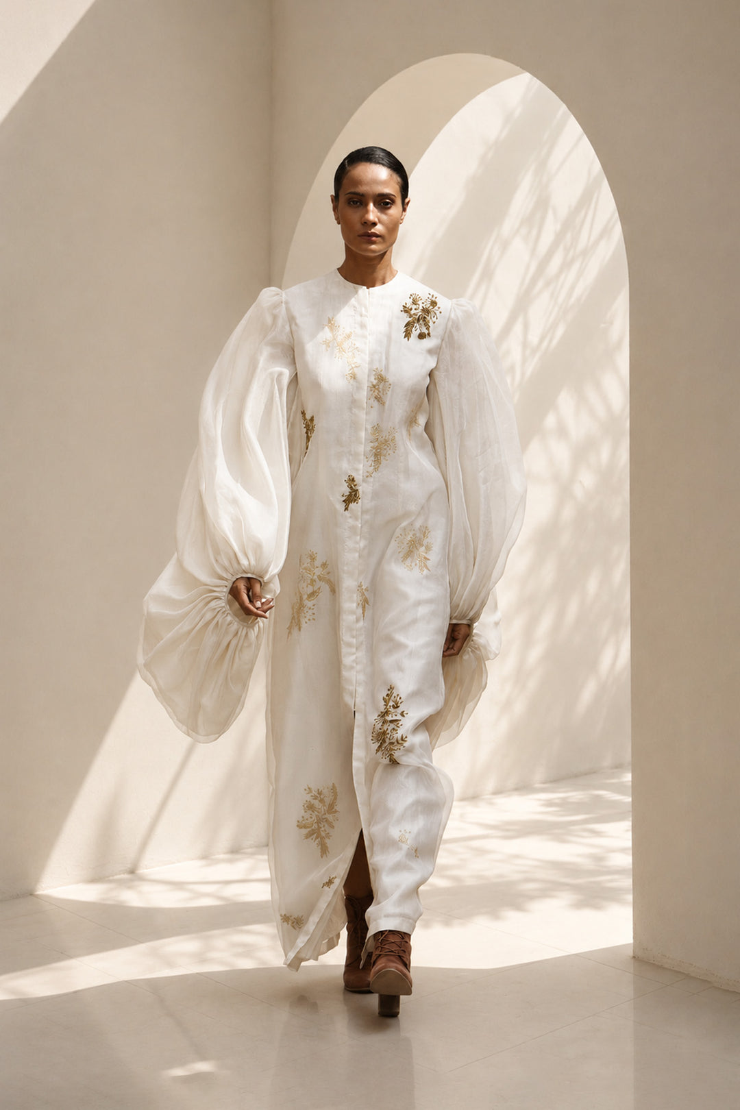 Ivory statement dress featuring dramatic sheer balloon sleeves and delicate botanical embroidery.