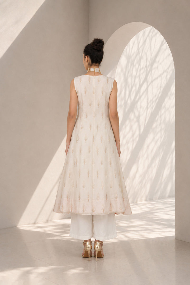 Ivory kurta set adorned with delicate motifs, elegant notch neckline, straight silhouette with a relaxed fit paired with wide-leg trousers.