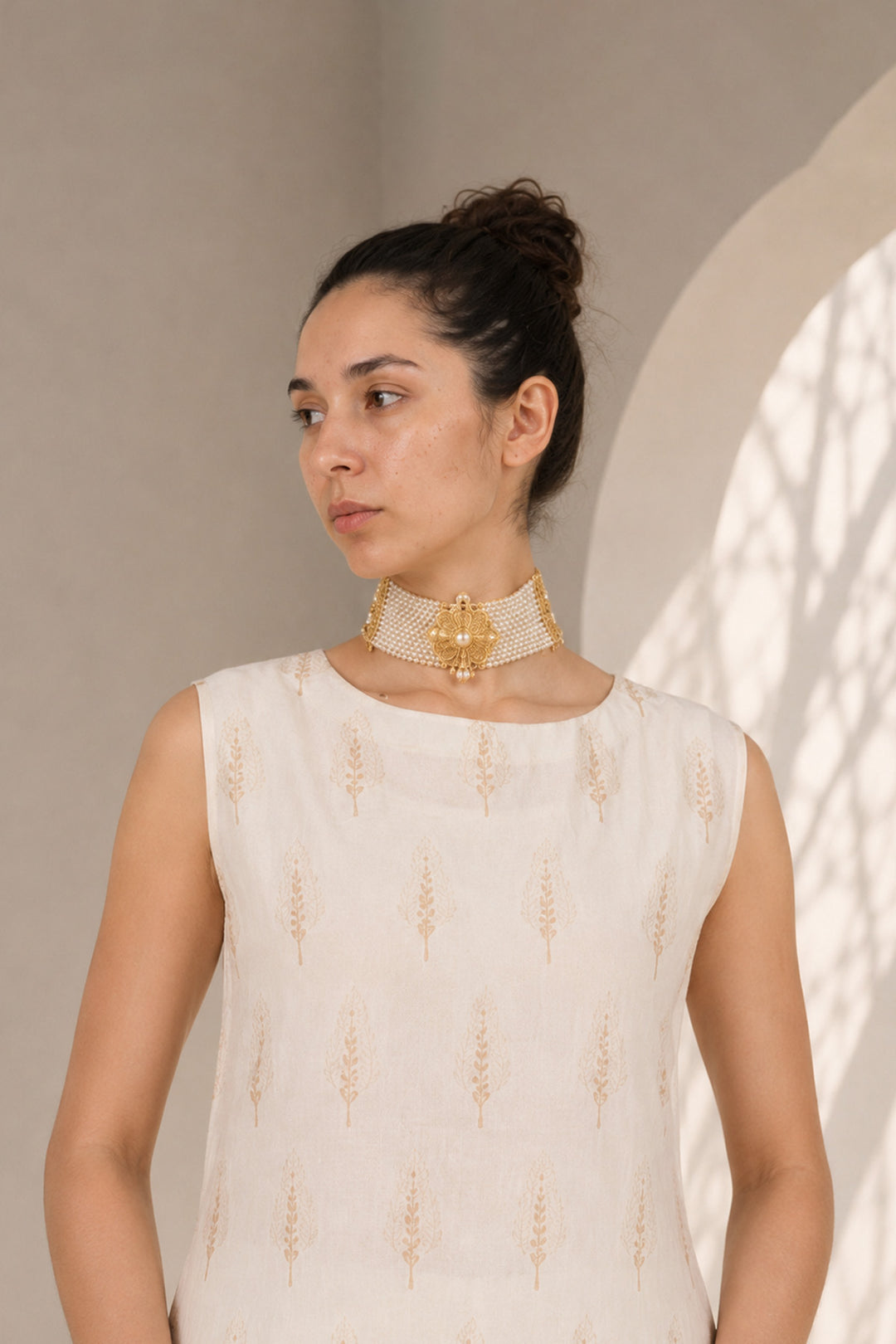 Ivory kurta set adorned with delicate motifs, elegant notch neckline, straight silhouette with a relaxed fit paired with wide-leg trousers.