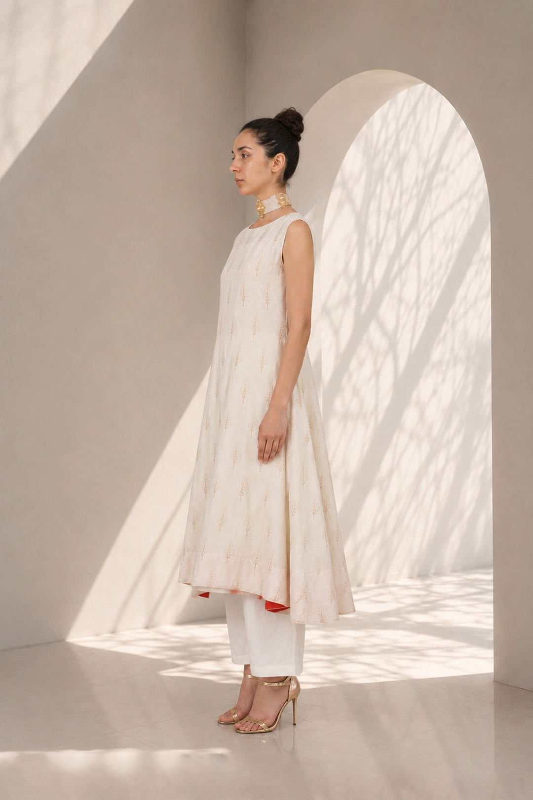 Ivory kurta set adorned with delicate motifs, elegant notch neckline, straight silhouette with a relaxed fit paired with wide-leg trousers.