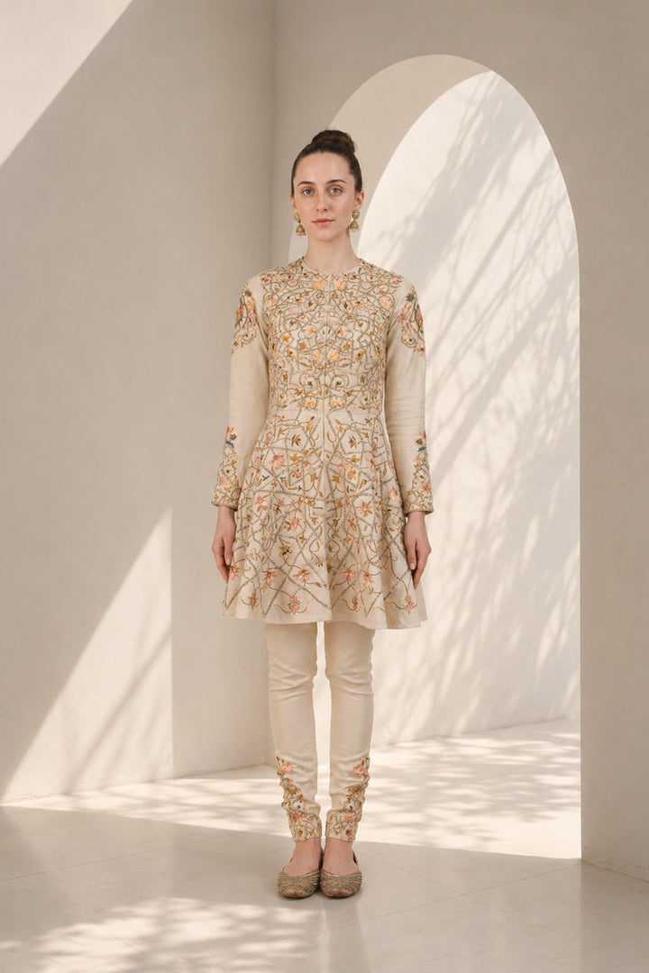 Ivory embroidered kurta set featuring a flattering fit-and-flare silhouette and refined artisanal detailing.