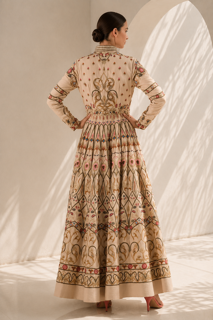 Ivory embroidered gown featuring a regal mandarin collar, full-length sleeves, fitted bodice with a voluminous flared silhouette.