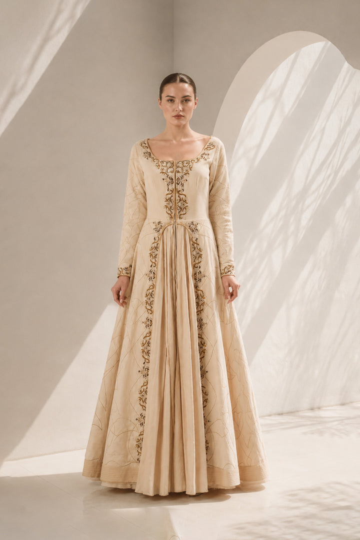 Ivory embroidered gown featuring a elegant scoop neckline, full-length sleeves, sculpted bodice, graceful front pleats.