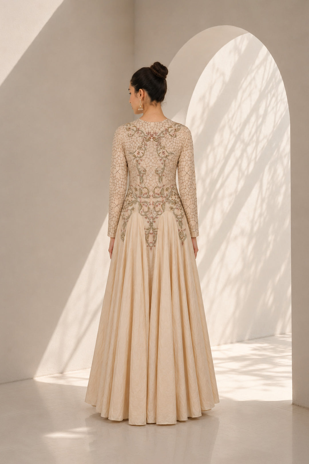 Ivory embroidered gown adorned with intricate floral embroidery, featured with elegant round neckline, fitted bodice, full-length fitted sleeves.
